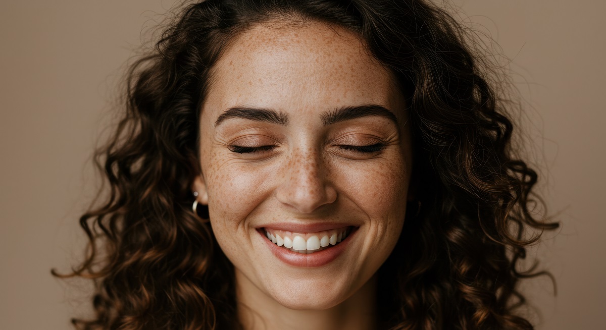 Smiling Woman with Freckles: Radiant Joy & Natural Beauty | Portrait of a Happy, Curly-Haired Model, Skin, Face
